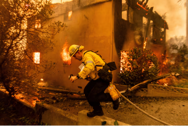 Winds forecast to subside but Los Angeles wildfires continue to rage
