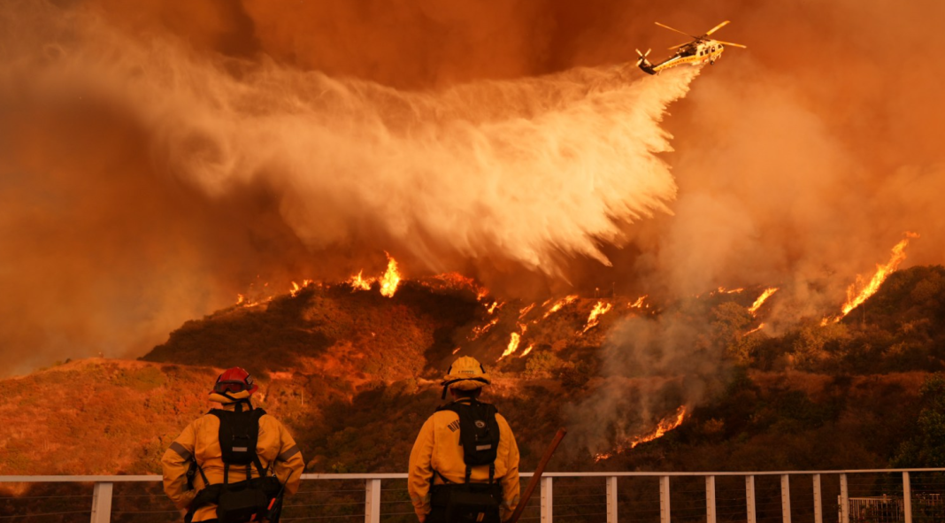 As winds pick up, LA firefighters battle to contain inferno